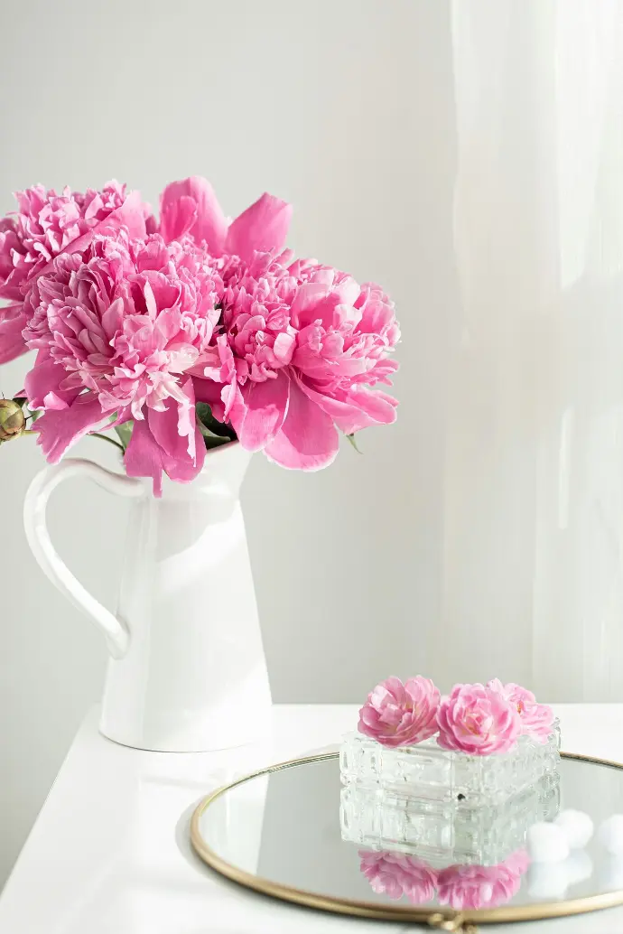 pink flowers in white ceramic vase